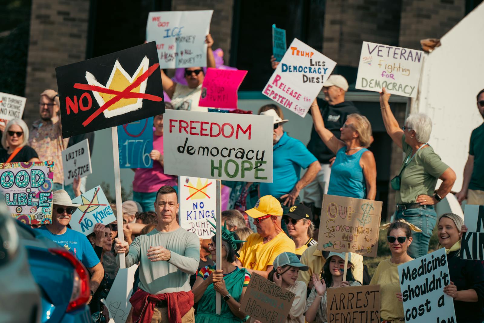 People holding signs at a pro-democracy protest